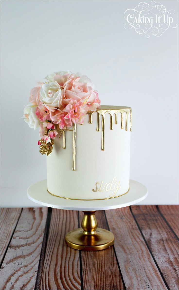 classy and elegant golden drizzle 60th birthday cake with