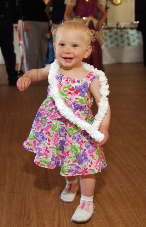 photo of a one year old girl dancing at a birthday party in san diego