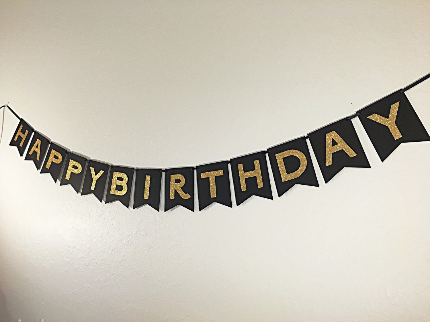 happy birthday banner in black and gold